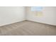 Cozy bedroom with plush carpet, neutral walls, and natural light from a window at 3732 S 87Th Dr, Tolleson, AZ 85353