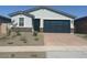 Charming single-story home with a two-car garage and desert landscaping in front at 3732 S 87Th Dr, Tolleson, AZ 85353