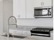 Kitchen features granite countertops, stainless steel appliances, modern faucet and white cabinetry at 3732 S 87Th Dr, Tolleson, AZ 85353