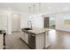 Kitchen island with granite countertops, stainless steel appliances and a view of the living room and patio at 3732 S 87Th Dr, Tolleson, AZ 85353