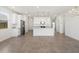 Open-concept kitchen with white cabinetry, granite countertops, stainless appliances and an island with pendant lights at 3732 S 87Th Dr, Tolleson, AZ 85353