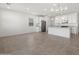 Bright and airy kitchen features stainless steel appliances, a granite island, and modern lighting fixtures at 3732 S 87Th Dr, Tolleson, AZ 85353