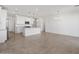 Bright kitchen with white cabinetry, stainless steel appliances, a granite island, and modern lighting at 3732 S 87Th Dr, Tolleson, AZ 85353