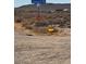 Exterior neighborhood street view with dirt road and sign pointing to Vineyard Road in the background at 385 W Vineyard Rd, Tonopah, AZ 85354