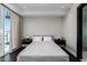 Bright bedroom with a queen-size bed, nightstands, hardwood floors and large windows at 4422 N 75Th St # 6007, Scottsdale, AZ 85251