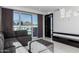Bright living room showcasing a gray sectional sofa, ottoman, and floor-to-ceiling windows with views at 4422 N 75Th St # 6007, Scottsdale, AZ 85251