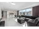Open-concept living space with sofa, ottoman, and floor-to-ceiling windows blending seamlessly with the kitchen at 4422 N 75Th St # 6007, Scottsdale, AZ 85251