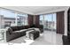 Bright living room featuring a sectional sofa, ottoman, floor-to-ceiling windows, and elegant tile floors at 4422 N 75Th St # 6007, Scottsdale, AZ 85251