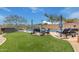 Expansive backyard with a refreshing pool, hot tub, lush artificial turf, and comfortable lounge area at 4514 E Coyote Wash Dr, Cave Creek, AZ 85331