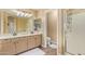 Bathroom featuring double sinks, a walk-in shower, and neutral-toned cabinets at 4514 E Coyote Wash Dr, Cave Creek, AZ 85331