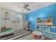 Colorful bedroom with a blue accent wall, toy storage, and a ceiling fan at 4514 E Coyote Wash Dr, Cave Creek, AZ 85331