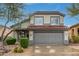 Charming two-story home with a tile roof, desert landscaping, and a two-car garage at 4514 E Coyote Wash Dr, Cave Creek, AZ 85331
