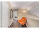 Upstairs hallway with hardwood floors and an orange accent chair at 4514 E Coyote Wash Dr, Cave Creek, AZ 85331