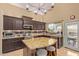 Well-equipped kitchen with a granite island, modern appliances, and dark wood cabinets at 4514 E Coyote Wash Dr, Cave Creek, AZ 85331