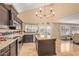 Bright kitchen with modern appliances, granite counters, dark cabinetry and double doors at 4514 E Coyote Wash Dr, Cave Creek, AZ 85331