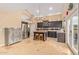 Well-lit kitchen with stainless steel appliances, dark cabinets, and a center island at 4514 E Coyote Wash Dr, Cave Creek, AZ 85331