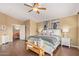Inviting main bedroom with hardwood floors, a ceiling fan, and decorative wall art at 4514 E Coyote Wash Dr, Cave Creek, AZ 85331