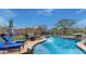 Beautiful pool area with rock waterfall feature, lounge chairs, and outdoor fire pit, perfect for entertaining at 4514 E Coyote Wash Dr, Cave Creek, AZ 85331