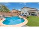Gorgeous backyard showcasing a swimming pool, artificial grass, lounge area, and a covered patio space at 4514 E Coyote Wash Dr, Cave Creek, AZ 85331