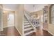 Hallway with wooden staircase leading to the upper level and an archway leading to the dining room at 4514 E Coyote Wash Dr, Cave Creek, AZ 85331