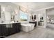 Bright, spacious bathroom with dual vanities, soaking tub, and modern chandelier at 528 E Ashurst Dr, Phoenix, AZ 85048