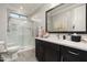 Modern bathroom with a glass shower, spacious vanity, and contemporary fixtures and art at 528 E Ashurst Dr, Phoenix, AZ 85048