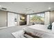 Airy primary bedroom with sliding barn door, seating area, and TV at 528 E Ashurst Dr, Phoenix, AZ 85048