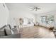 Bright living room with a ceiling fan, light wood floors and built-in storage shelves at 5850 E Le Marche Ave, Scottsdale, AZ 85254