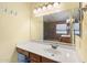Bright bathroom featuring a large mirror, updated vanity, and a connected shower at 5932 W Poinsettia Dr, Glendale, AZ 85304