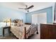 Cozy bedroom with soft blue walls, comfortable bedding, and plenty of natural light at 5932 W Poinsettia Dr, Glendale, AZ 85304