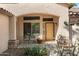 Inviting front porch with a cozy seating area and beautiful desert landscaping at 5932 W Poinsettia Dr, Glendale, AZ 85304