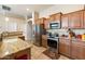 Modern kitchen featuring stainless steel appliances and ample counter space at 5932 W Poinsettia Dr, Glendale, AZ 85304