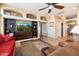 Spacious living room with built-in shelving, a ceiling fan, and comfortable seating area at 5932 W Poinsettia Dr, Glendale, AZ 85304