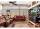 Comfortable living room featuring a large window, media center, and plush seating at 5932 W Poinsettia Dr, Glendale, AZ 85304