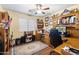 Functional office space with custom built-ins, ample desk space, and natural light at 5932 W Poinsettia Dr, Glendale, AZ 85304