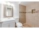 Bathroom featuring a tiled shower with niche, modern vanity, and patterned flooring at 6031 W Hearn Rd, Glendale, AZ 85306