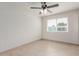 Bright bedroom featuring a ceiling fan, neutral walls, and a window with natural light at 6031 W Hearn Rd, Glendale, AZ 85306