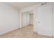 Bedroom with sliding mirrored closet and doorway, showcasing the tile flooring at 6031 W Hearn Rd, Glendale, AZ 85306