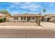 Single-story home with desert landscaping, covered carport and cozy charm at 6031 W Hearn Rd, Glendale, AZ 85306