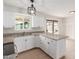 Bright kitchen boasts white cabinets, granite countertops, and stainless appliances at 6031 W Hearn Rd, Glendale, AZ 85306