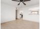 Open living space shows tile flooring with a view to the kitchen with white cabinetry at 6031 W Hearn Rd, Glendale, AZ 85306