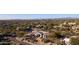 Expansive aerial view of a community showcasing lush desert landscaping and tile roofed homes at 6240 E Ironwood Dr, Scottsdale, AZ 85266