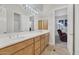 Bright bathroom with double sinks, wood cabinets, and shower at 6240 E Ironwood Dr, Scottsdale, AZ 85266
