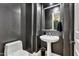 Stylish powder room features a pedestal sink, decorative walls, and modern fixtures at 6240 E Ironwood Dr, Scottsdale, AZ 85266