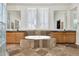 The primary bathroom features a large tub, dual sinks, a window with shutters, and a travertine floor at 6240 E Ironwood Dr, Scottsdale, AZ 85266