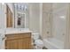 Bright bathroom features a tub-shower combination, wood vanity, and neutral color palette at 6240 E Ironwood Dr, Scottsdale, AZ 85266
