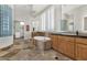 The primary bathroom boasts a soaking tub, dual vanities, and a glass block shower wall at 6240 E Ironwood Dr, Scottsdale, AZ 85266