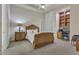 Bedroom with decorative wood bedframe, window shutters, neutral walls, and carpet at 6240 E Ironwood Dr, Scottsdale, AZ 85266