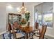 Formal dining room with a chandelier, a large window, and a china cabinet at 6240 E Ironwood Dr, Scottsdale, AZ 85266