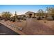 Paver driveway leading to a well-manicured property with mature landscaping and desert charm at 6240 E Ironwood Dr, Scottsdale, AZ 85266